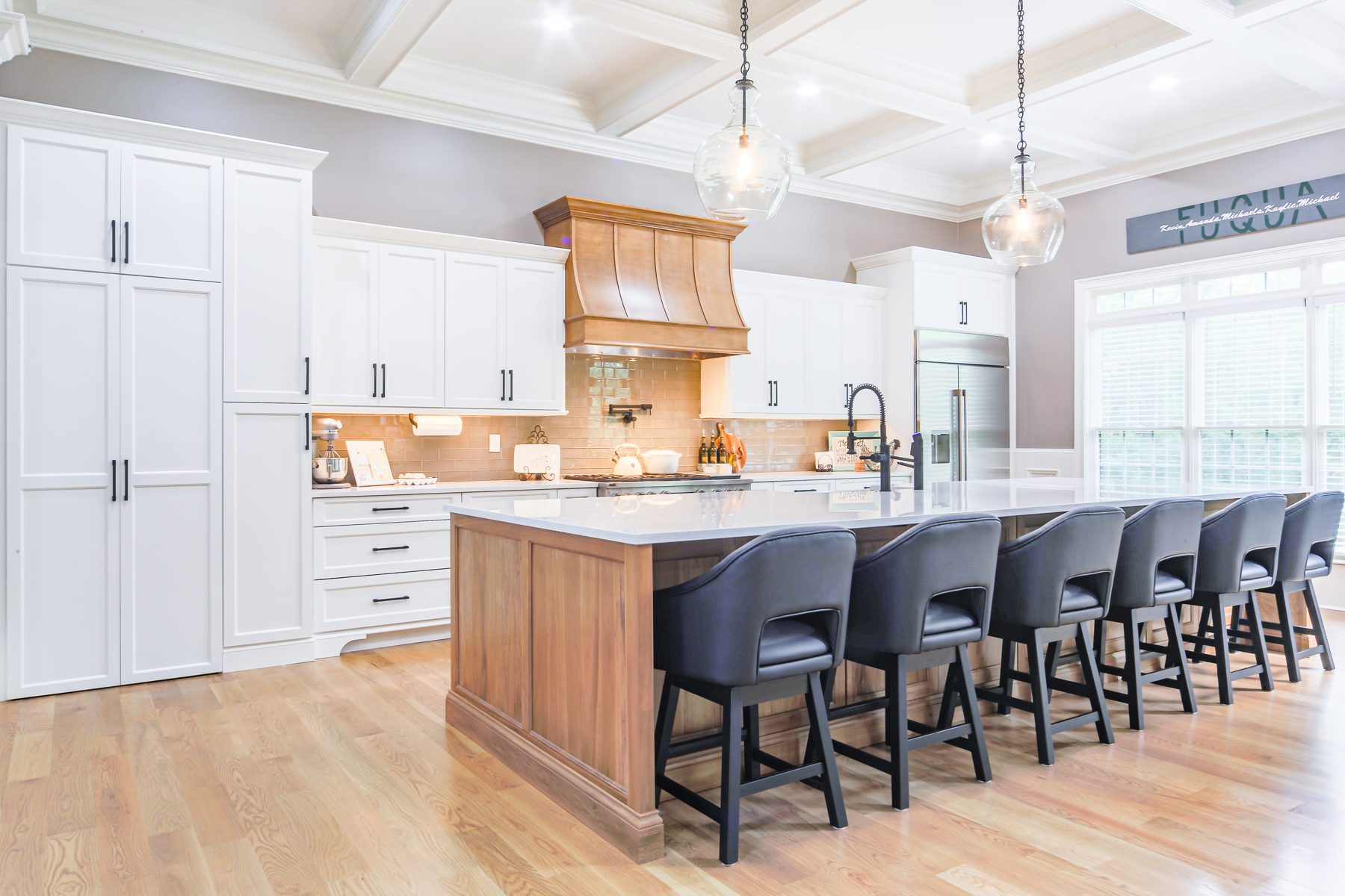 White kitchen with a large stained island seating ten