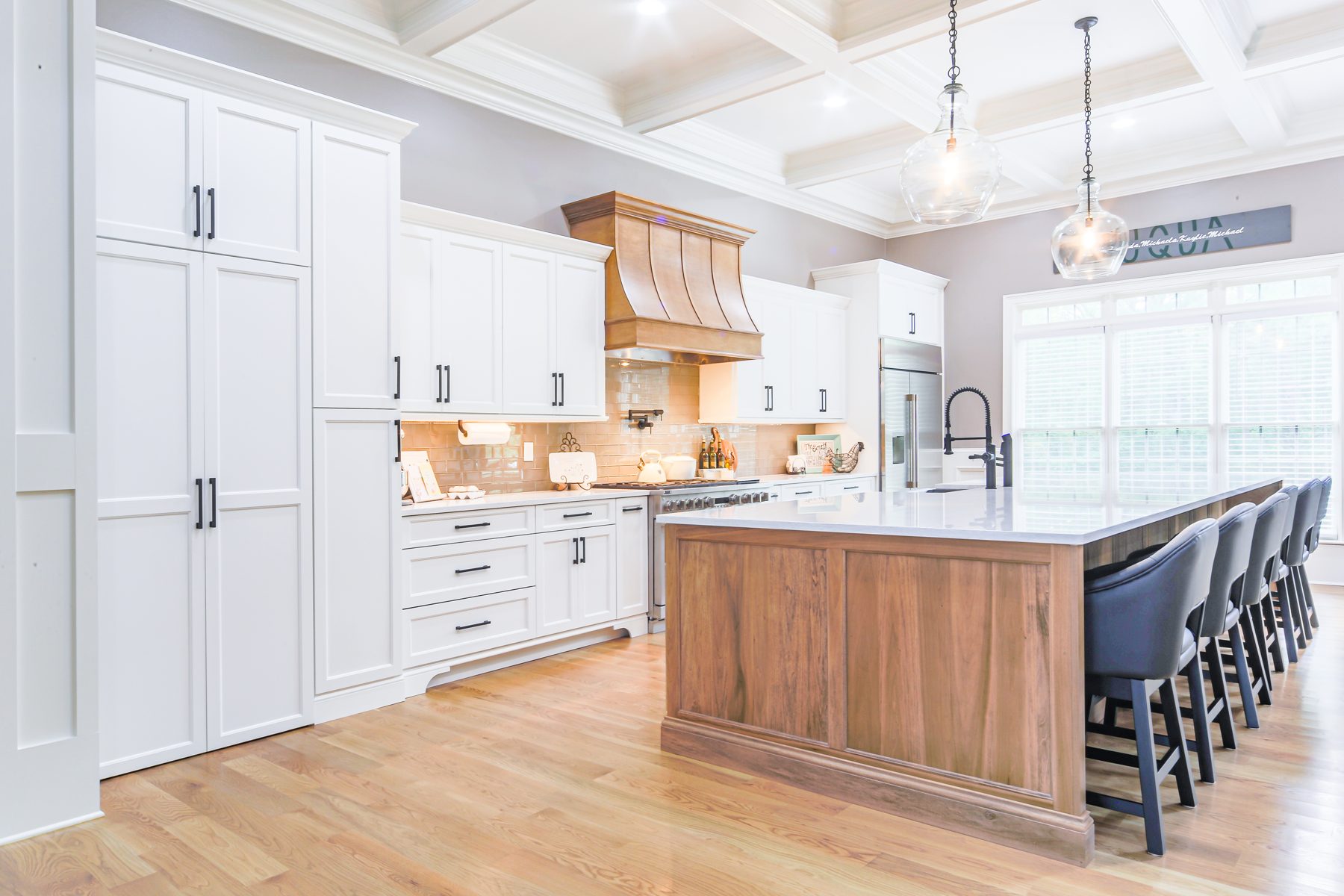 White shaker kitchen with a solid walnut island